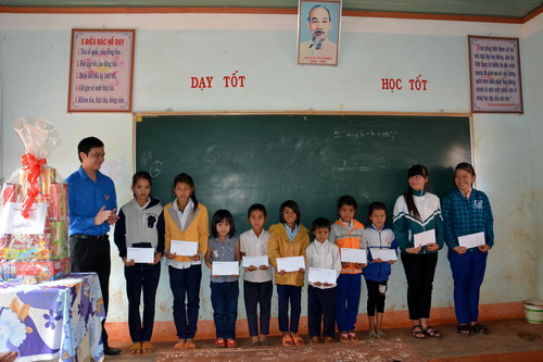 Đồng chí Bùi Quang Huy - Trưởng Ban Thanh niên trường học trao học bổng cho các em thiếu nhi